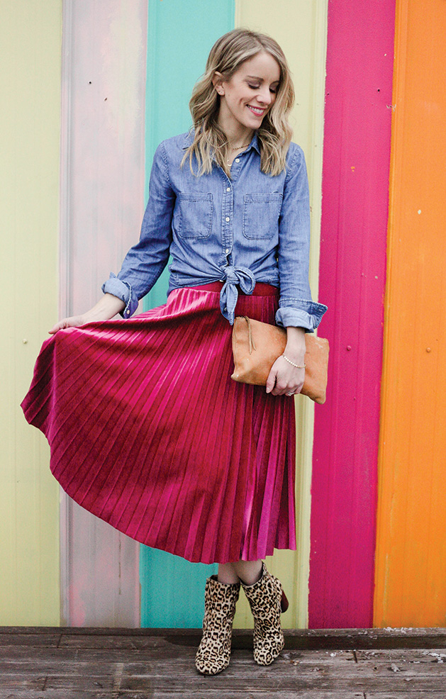 A fashion model wears animal print boots, a pink skirt and a chambray shirt