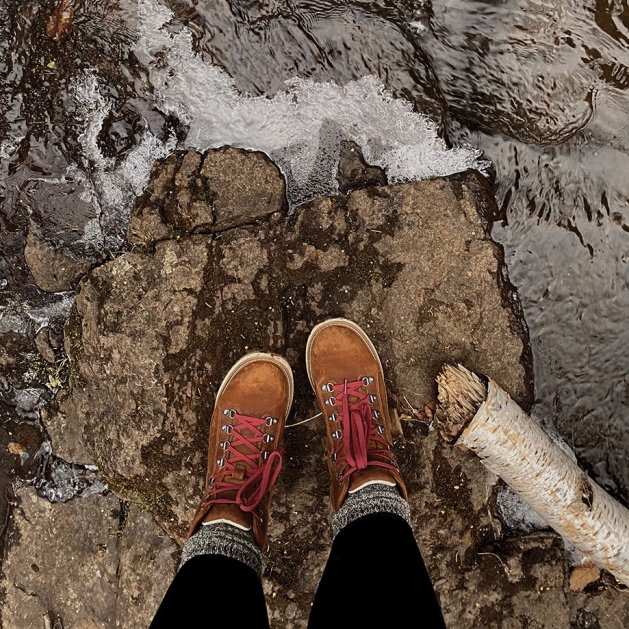 Travel Blogger Lizanne Lately Travel blogger Lizanne Lately standing on a rock overlooking Lake Superior.