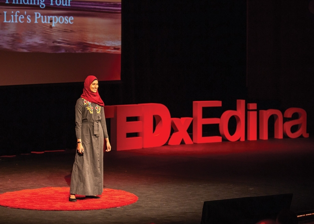 TEDxEdina speaker Nausheena Hussain on stage.
