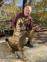 Denny Schulstad at the bronze sculpture of his golden retriever.