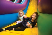 Kids play on an inflatable slide at Southdale Center's Bounce Town