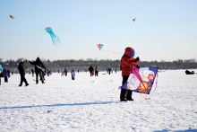 A child flies a kite at the Lake Harriet Kite Festival