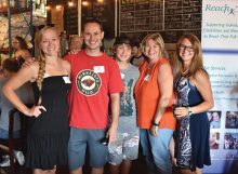 Attendees of Reach for Resources' yearly fundraiser, Reach On Tap, pose for a photo at Wooden Hill Brewing Company.