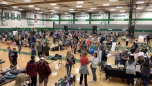 Families browse used gear at the Edina Give and Go gear swap.