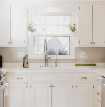 A white, clean kitchen.