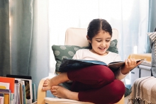 Young girl reading a picture book