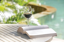 drinking wine while reading on patio
