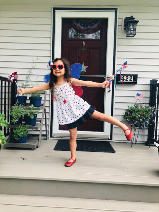 A girl poses on her Edina porch on the Fourth of July.