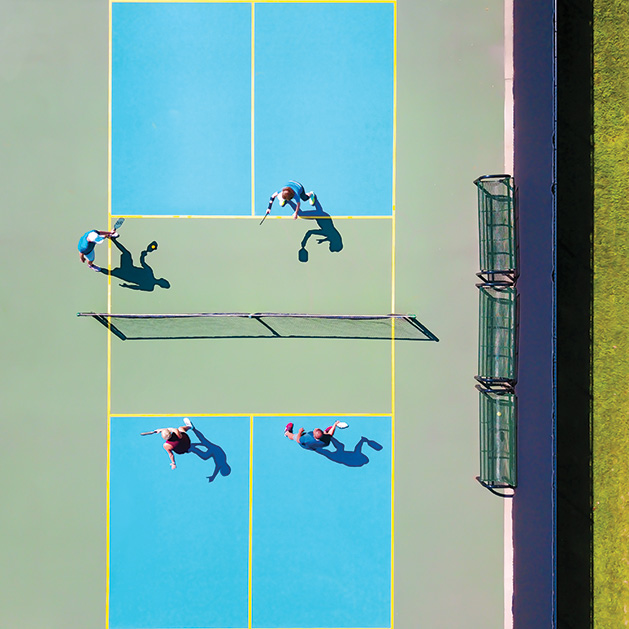 An overhead shot of a tennis court from See Them Shine