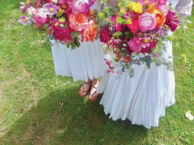 Women holding pink and orange bouquets