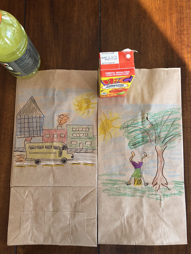 Lunch bag art depicting a school bus on the road and a kid doing a handstand